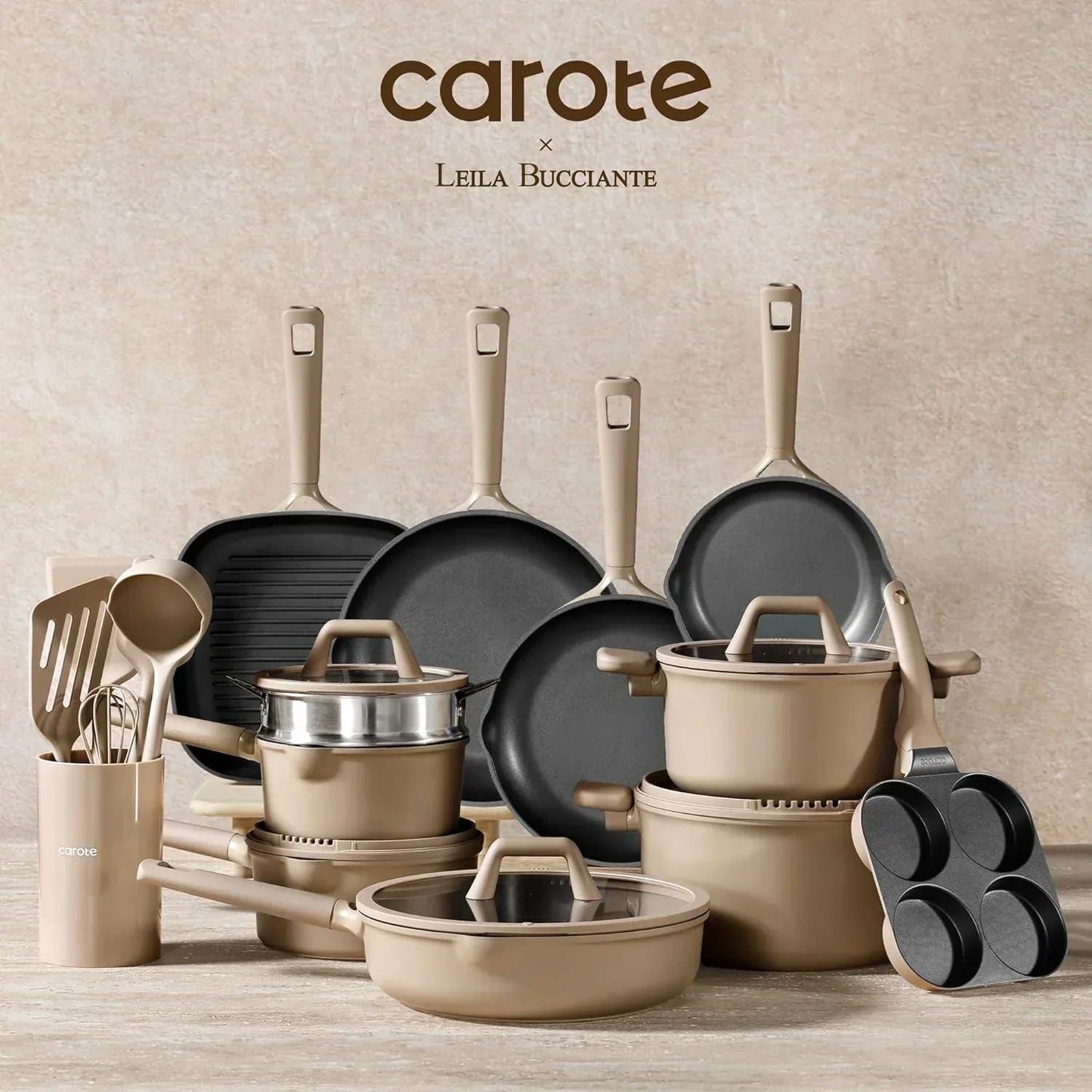 Beige nonstick cookware and utensil set with pots, pans, lids, and kitchen tools on a countertop.