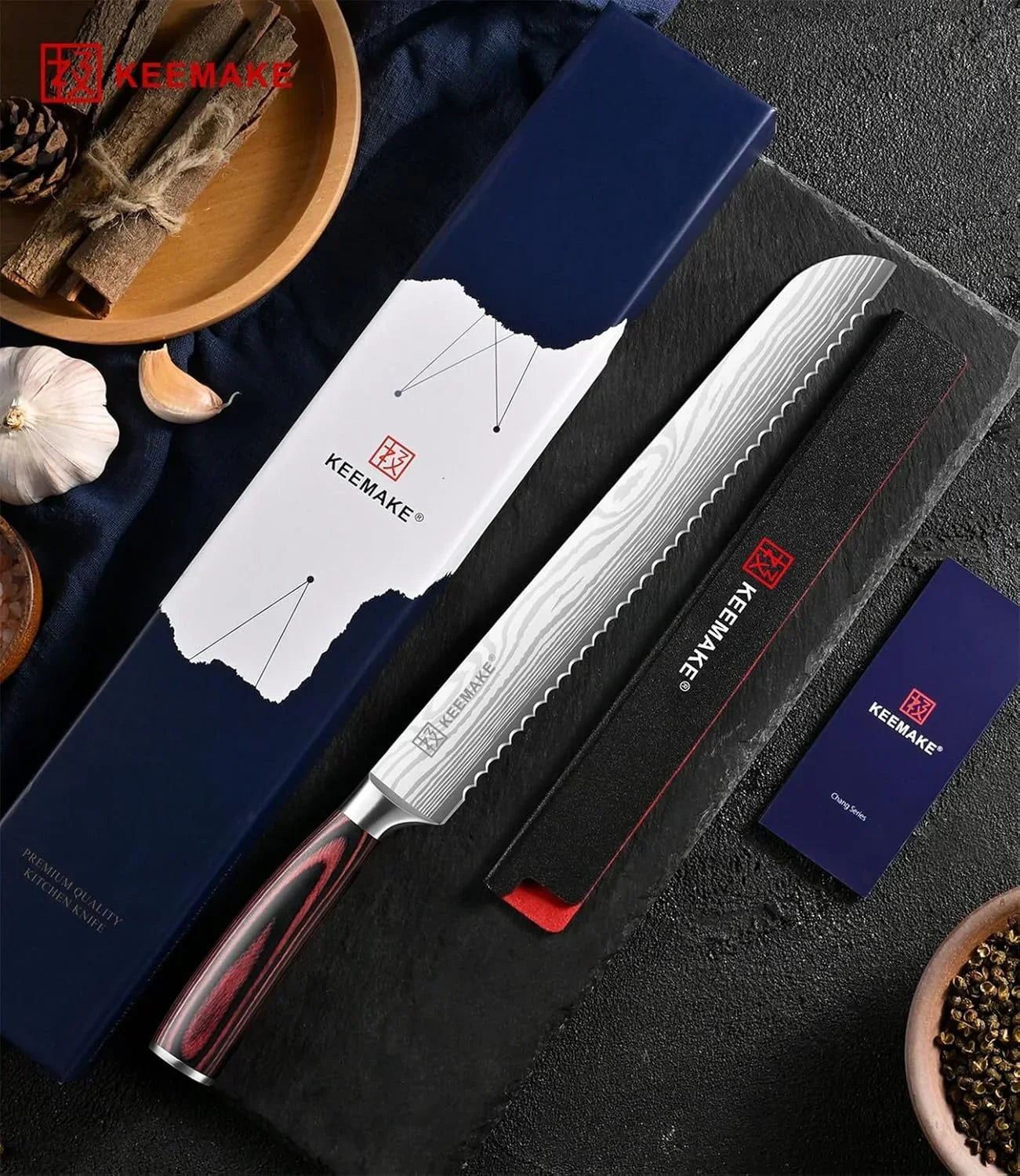 Keemake premium kitchen knife with serrated edge, red-black handle, and sleek packaging on dark slate