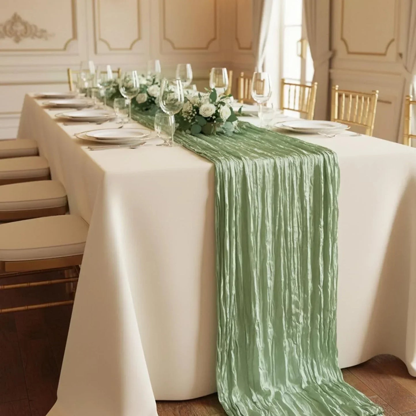 Elegant sage green crinkle table runner on white linen, perfect for wedding or dinner party table settings.
