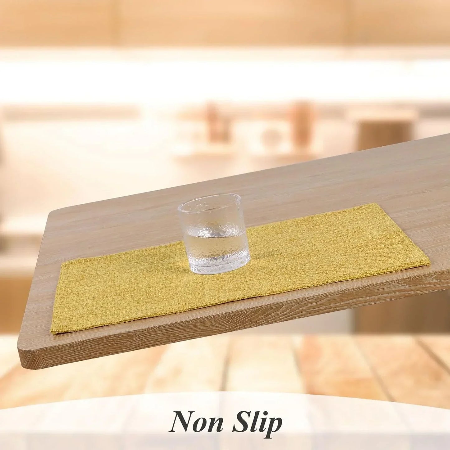 Yellow non-slip placemat on wooden table with glass, ideal for kitchen dining and table linens