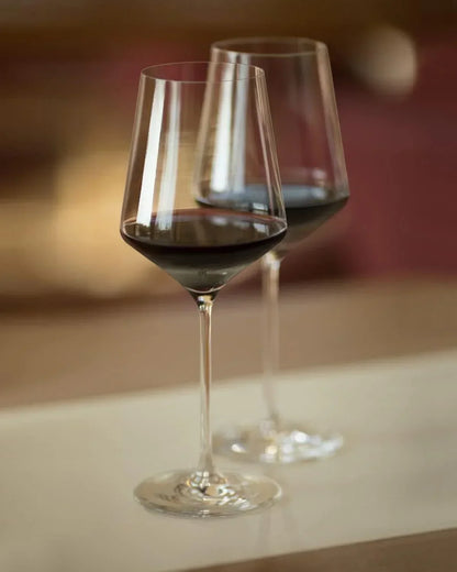 Elegant red wine glasses filled with wine, perfect for dining and entertaining