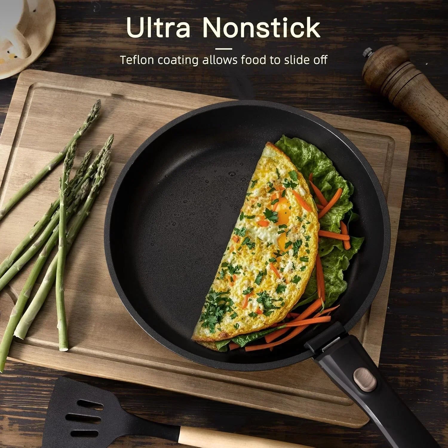 Nonstick frying pan with cooked omelette, vegetables, and kitchen utensils on wooden board