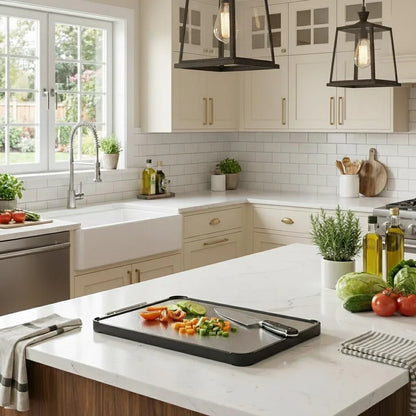 Black cutting board with chopped veggies on white kitchen island, modern farmhouse kitchen setup