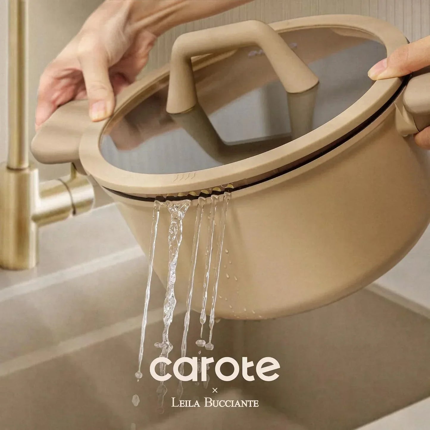 Beige nonstick pot with strainer lid draining water in kitchen sink, cookware in use