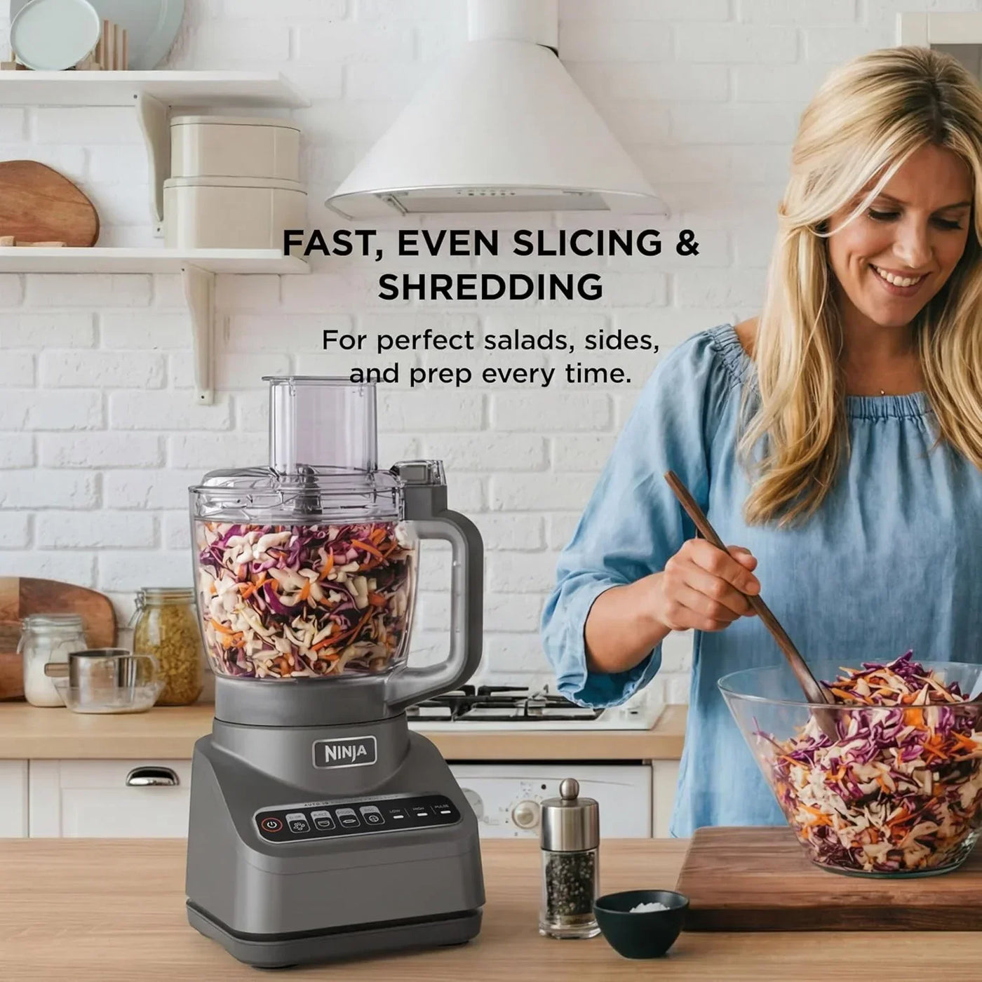 Ninja food processor slicing and shredding vegetables for salad in a bright kitchen