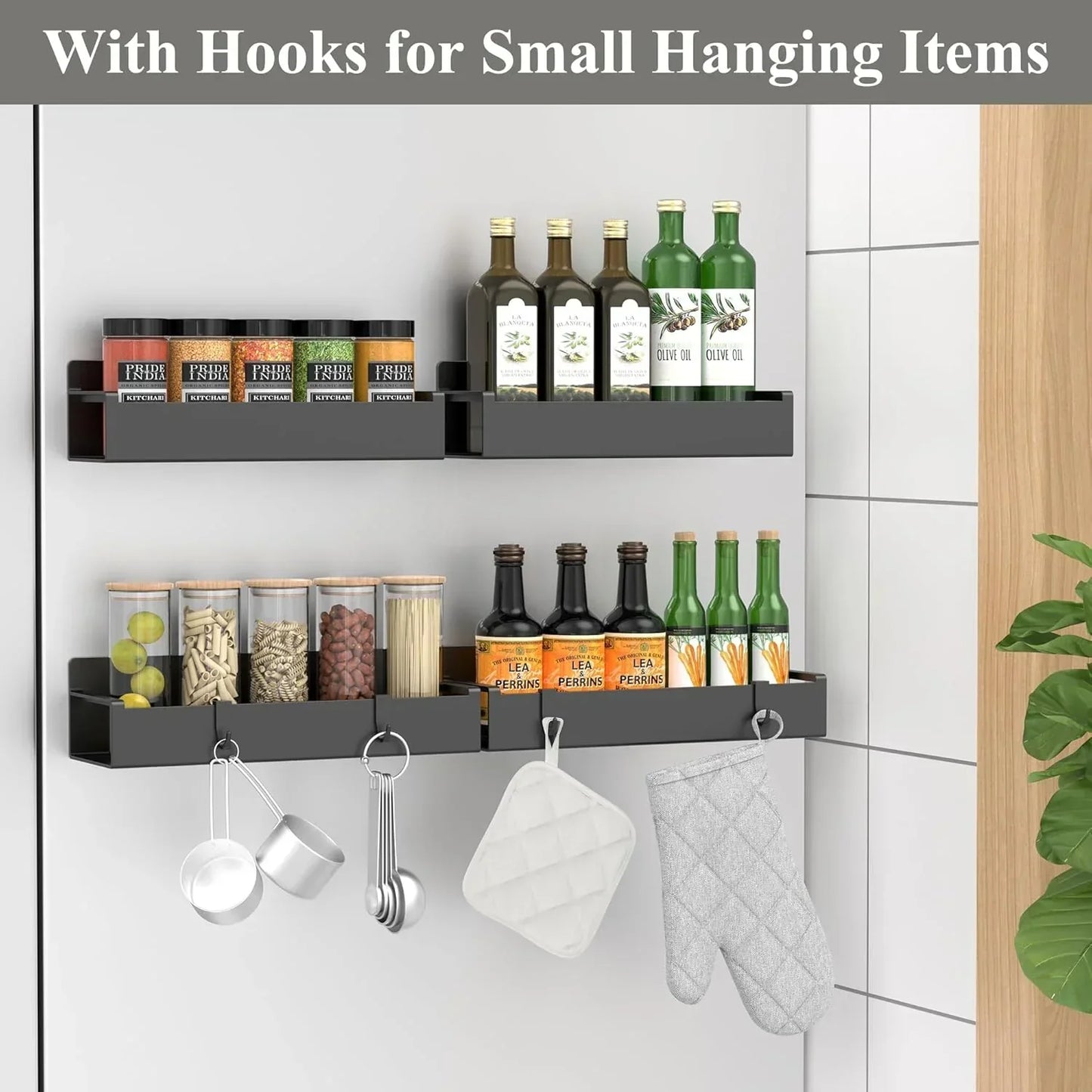 Wall-mounted kitchen shelves with hooks, holding spices, oil bottles, measuring cups, and oven mitts.
