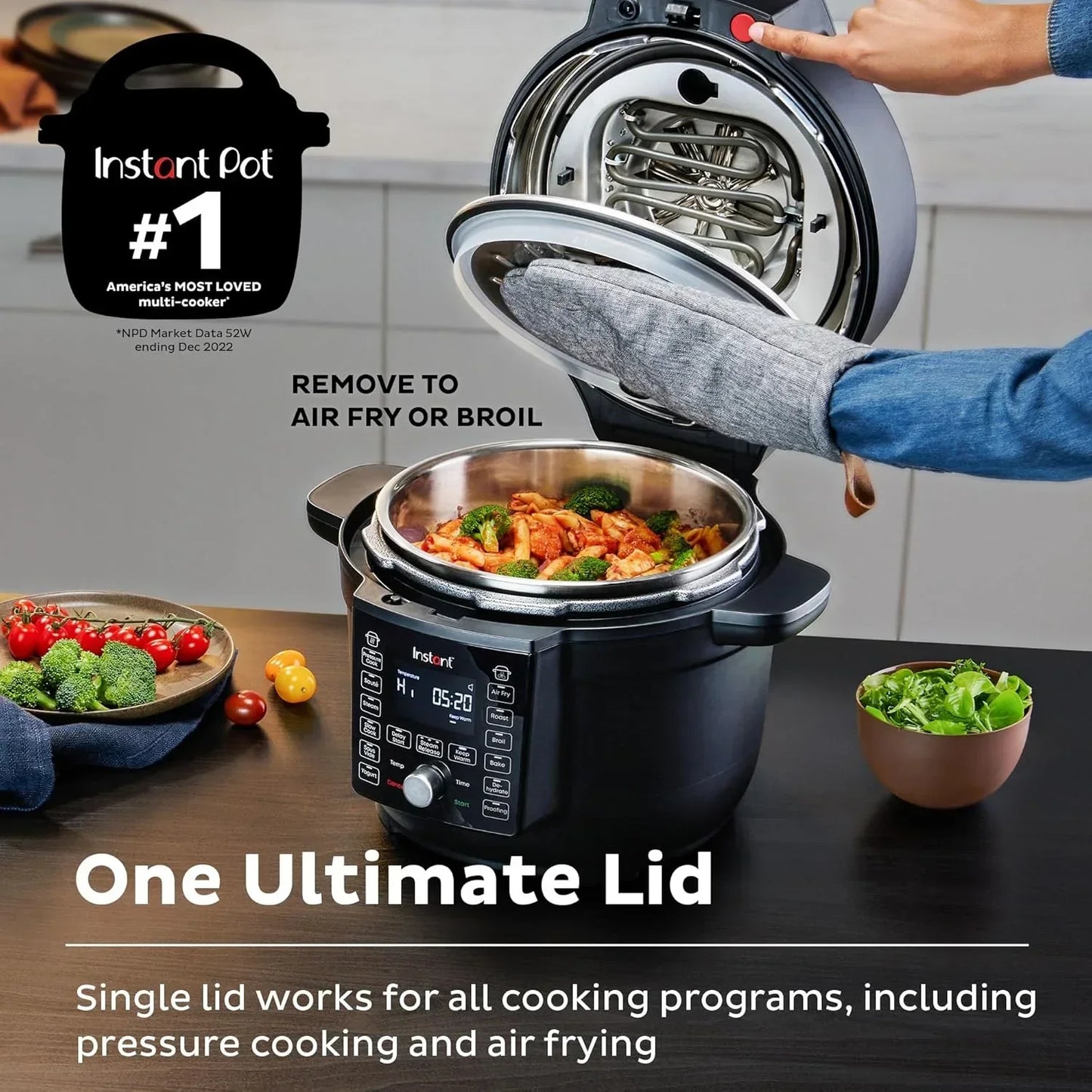 Instant Pot multi-cooker with removable air fry lid, cooking chicken and broccoli, kitchen countertop setup