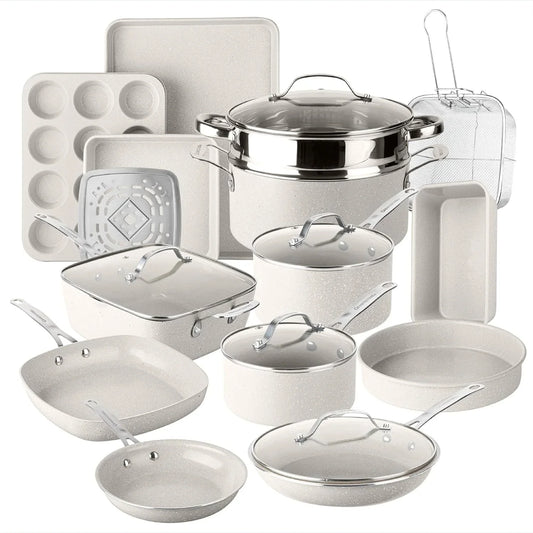 White cookware and bakeware set with pots, pans, baking trays, and lids on white background.