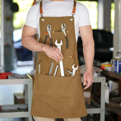 Brown canvas tool apron with wrenches and pliers in pockets, ideal for workshop or garage use.