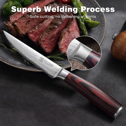 Damascus steel steak knife with red wood handle, slicing cooked steak on plate