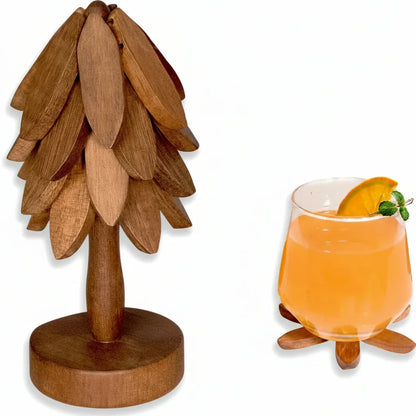 Wooden tree-shaped coaster set with glass of orange drink garnished with mint and orange slice