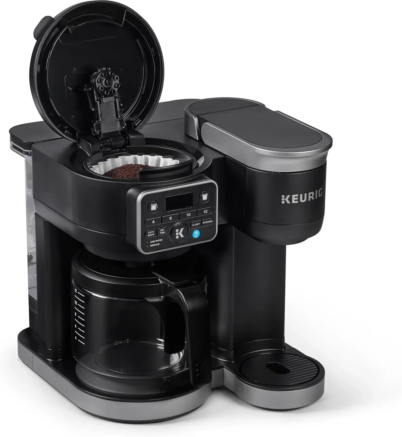 Keurig coffee maker with open lid, coffee grounds, and digital controls for brewing