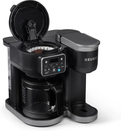 Keurig coffee maker with open lid, coffee grounds, and digital controls for brewing