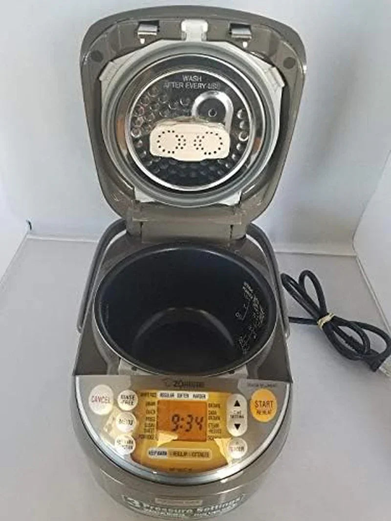 Open rice cooker with digital display, nonstick inner pot, and steam vent for kitchen cooking