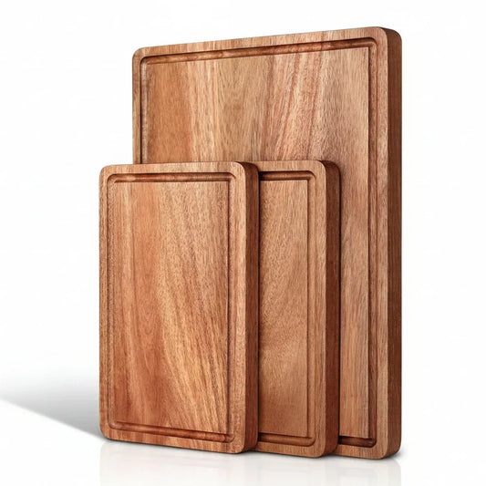 Set of three wooden cutting boards with juice grooves, ideal for kitchen prep and food prep tasks.