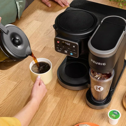 Keurig coffee maker brewing hot and iced coffee on wooden kitchen counter with mug and K-cup