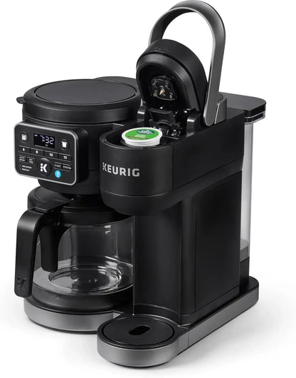 Keurig coffee maker with pod compartment open, digital display, and glass carafe for home kitchen use