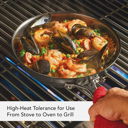 Seafood paella cooking on grill with high-heat tolerant pan, ideal for stove, oven, or grill use.