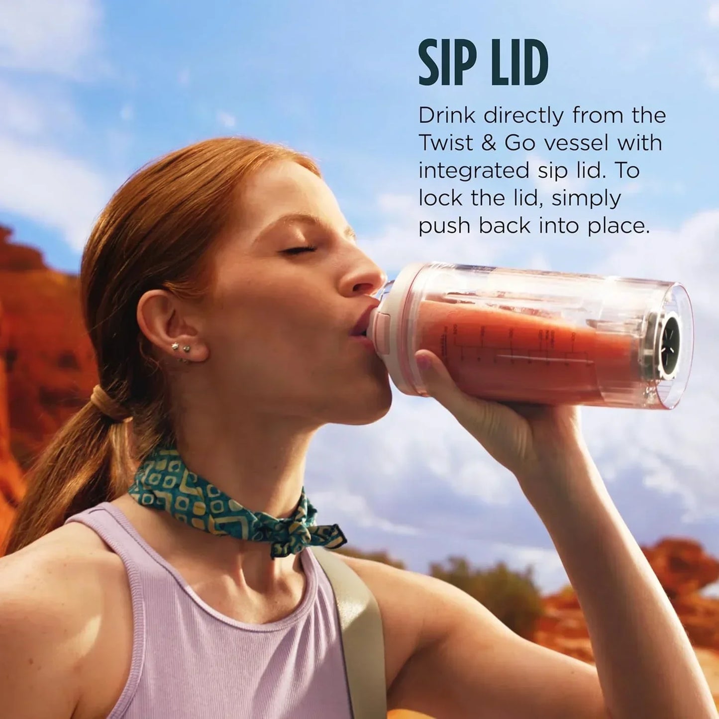Woman drinking smoothie from Twist & Go vessel with sip lid, perfect for on-the-go hydration and healthy living.
