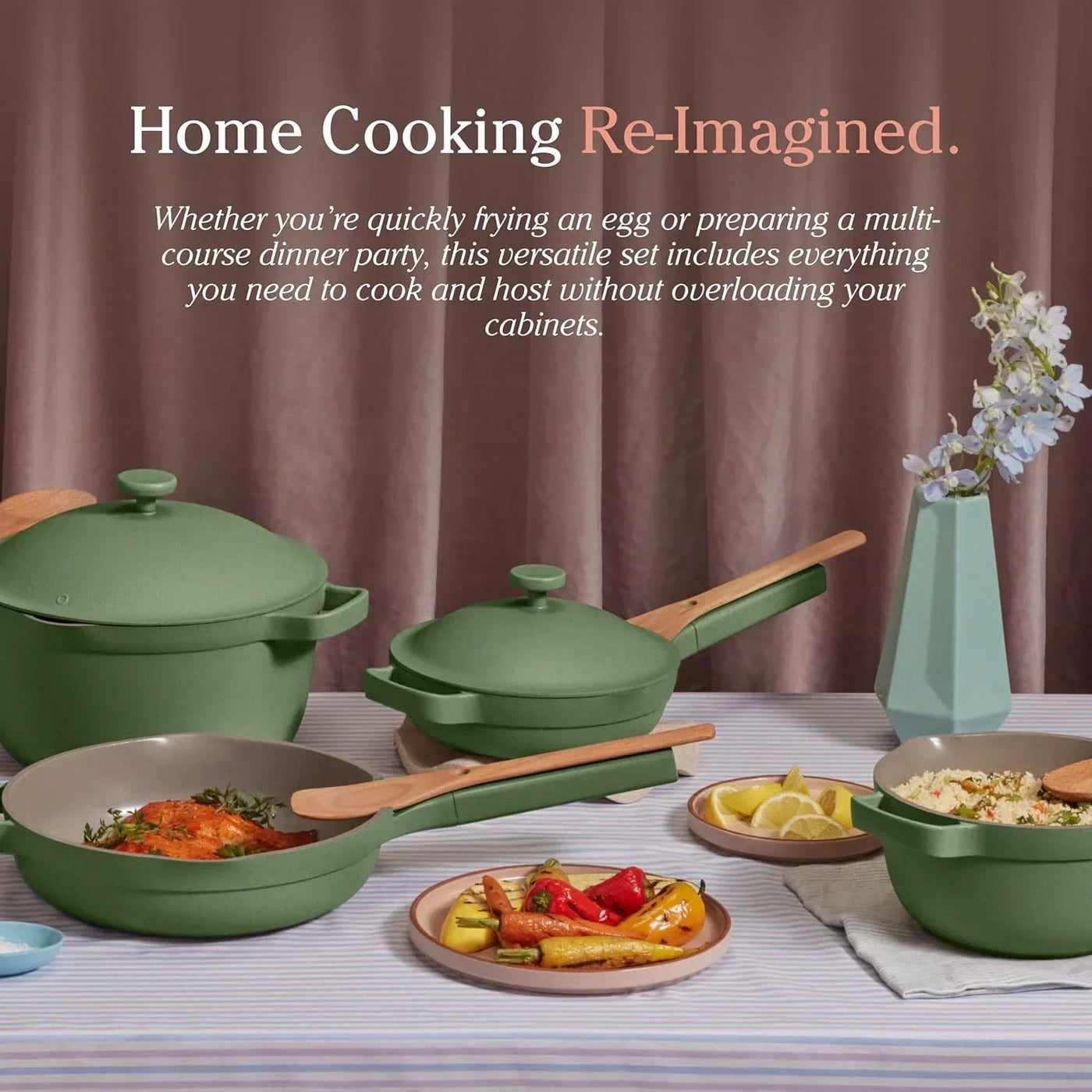 Green cookware set with wooden handles, featuring pots, pans, and served dishes on a striped tablecloth for home cooking.