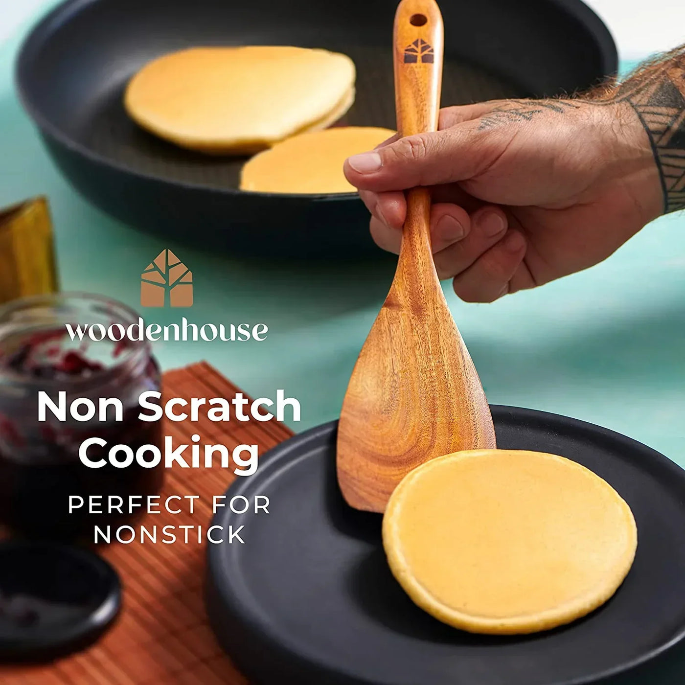 Wooden spatula flipping pancakes in nonstick pan, ideal for scratch-free cooking