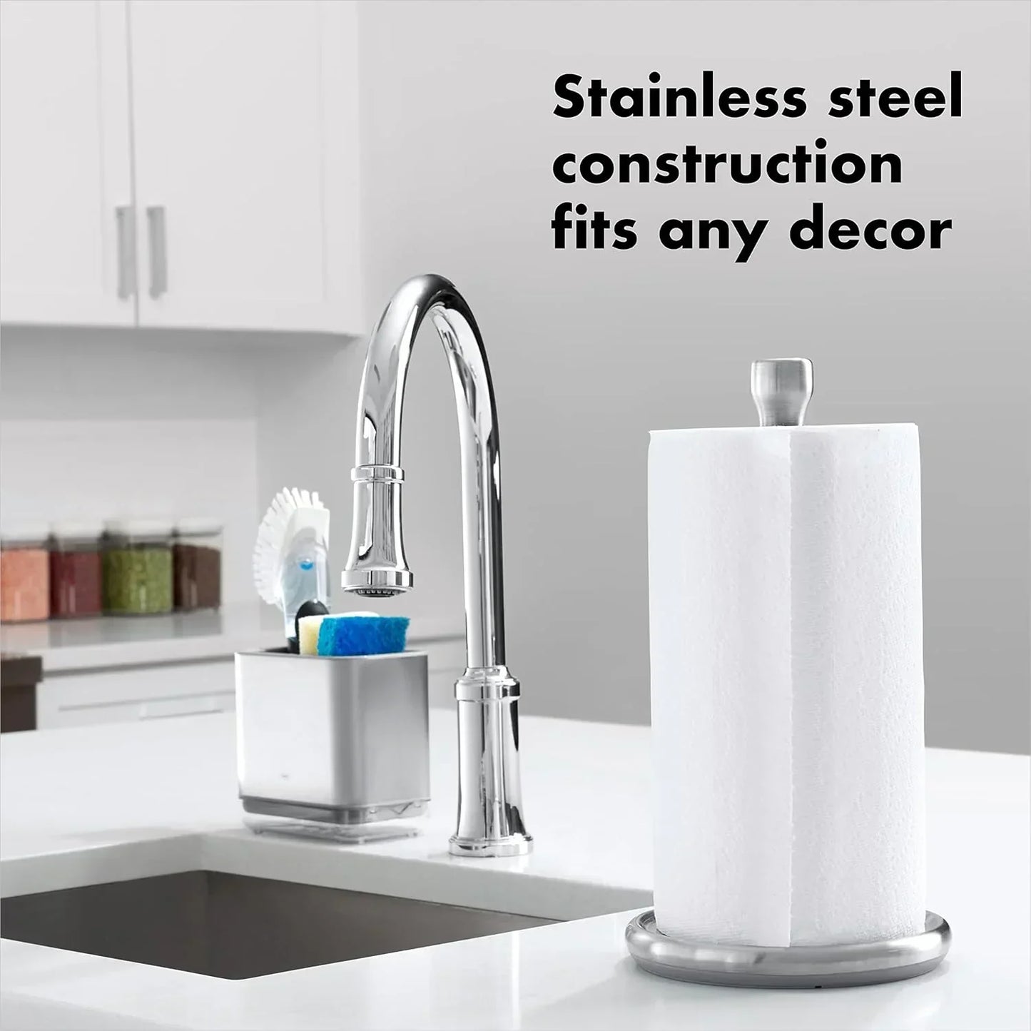 Stainless steel paper towel holder on kitchen counter with modern faucet and utensils