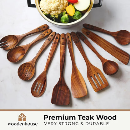Premium teak wood kitchen utensils set with spoons, spatulas, and ladles arranged around a pot of fresh vegetables.