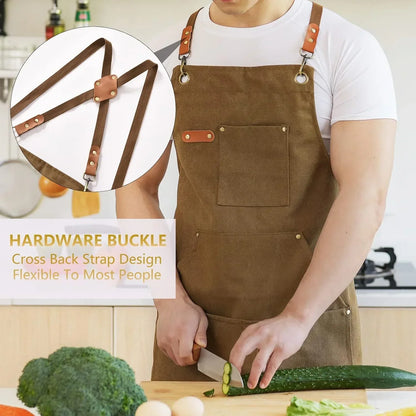 Brown canvas apron with cross-back straps, cutting cucumber in kitchen