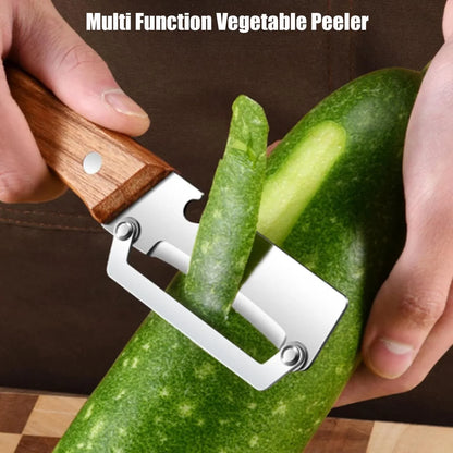 Hand using a multifunction vegetable peeler with wooden handle to peel green zucchini.