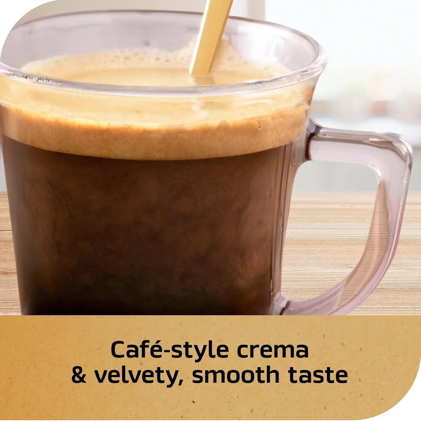 Café-style crema coffee in clear mug with golden spoon, velvety smooth taste