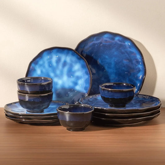 Blue ceramic dinnerware set with glossy glaze, featuring plates and bowls for modern kitchen dining