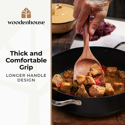 Wooden spoon stirring meat and veggies in a black skillet, featuring a thick, comfortable grip handle.