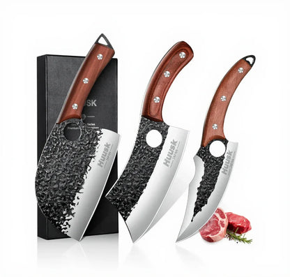 Set of three Japanese-style chef knives with hammered steel blades and wooden handles, displayed with a gift box and meat cuts.
