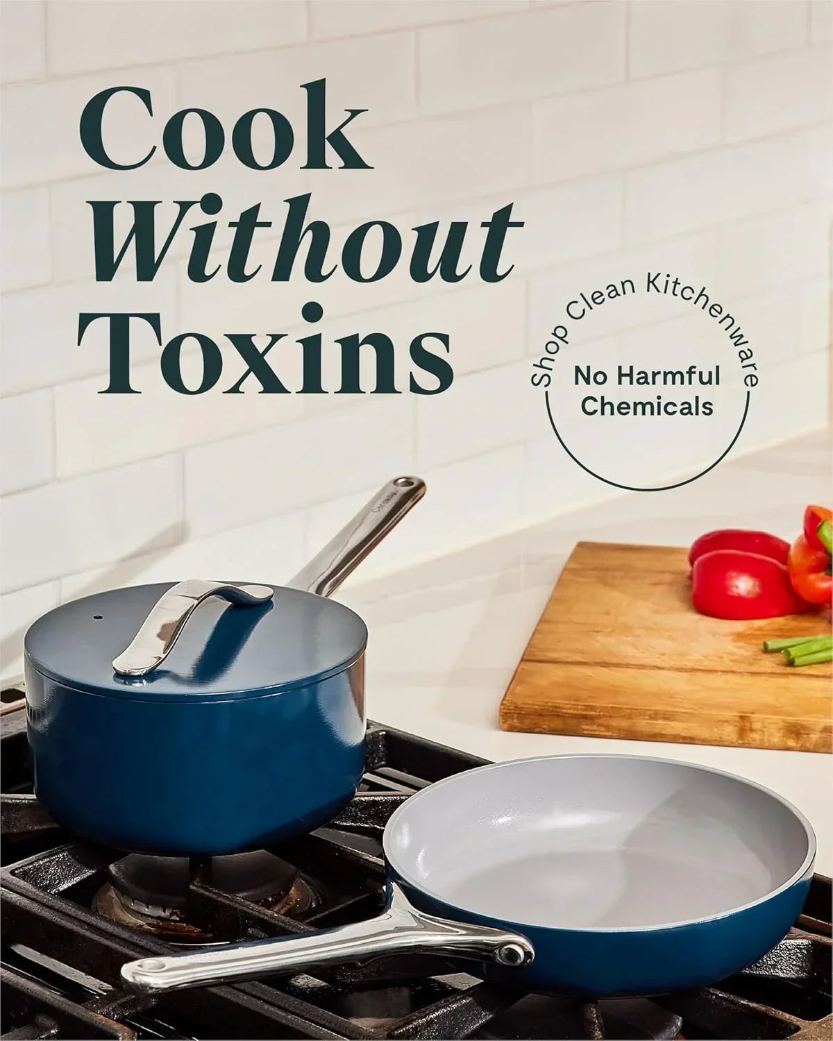 Non-toxic blue saucepan and frying pan on stove with fresh vegetables on a cutting board