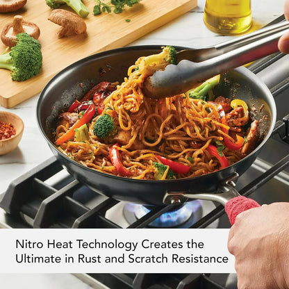Stir-fry noodles with broccoli and peppers in a nonstick pan on stove