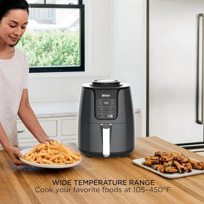 Ninja air fryer with crispy fries and chicken wings on kitchen counter