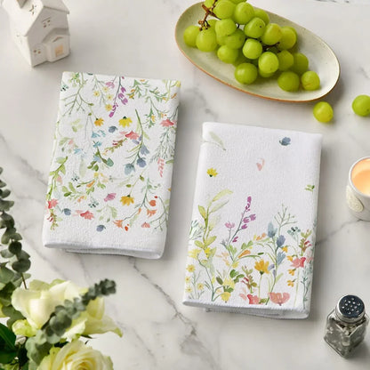 Floral kitchen towels with watercolor wildflowers on marble countertop, paired with green grapes and home decor