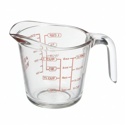 Clear glass measuring cup with red measurement markings for cups, ounces, and milliliters, ideal for baking and cooking.