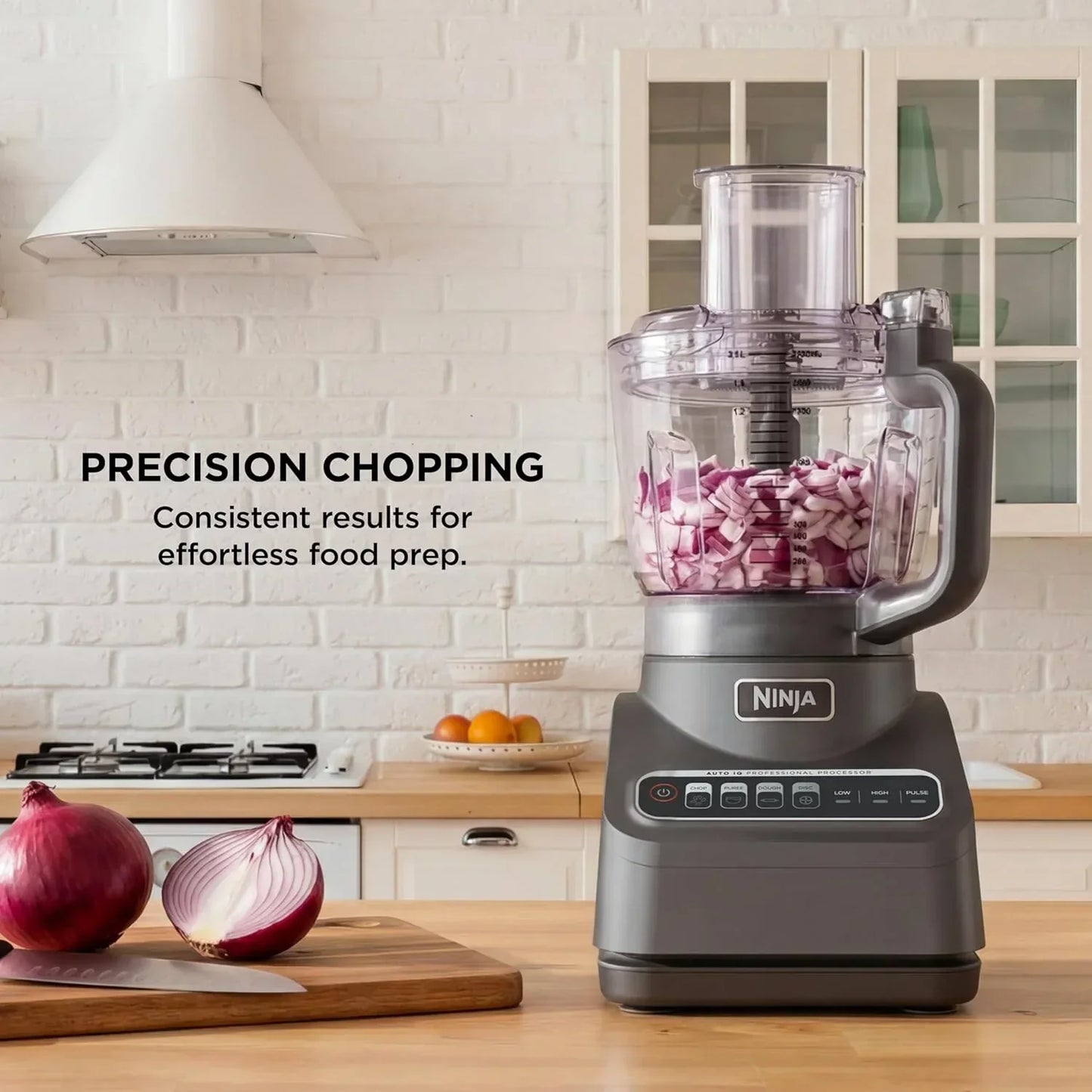 Ninja food processor chopping red onions for precision meal prep in a modern kitchen