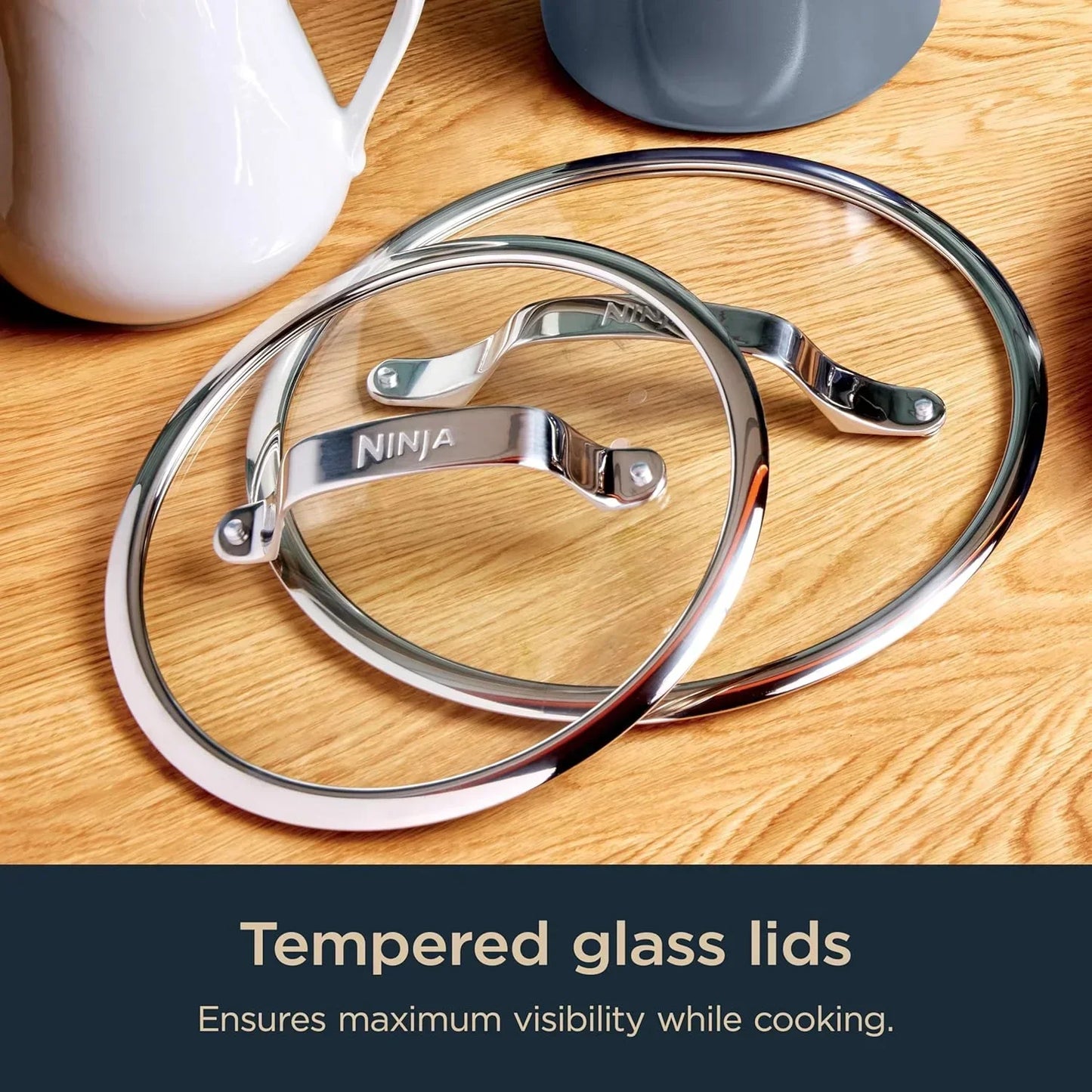 Tempered glass cookware lids with stainless steel handles for clear cooking visibility on wooden kitchen counter