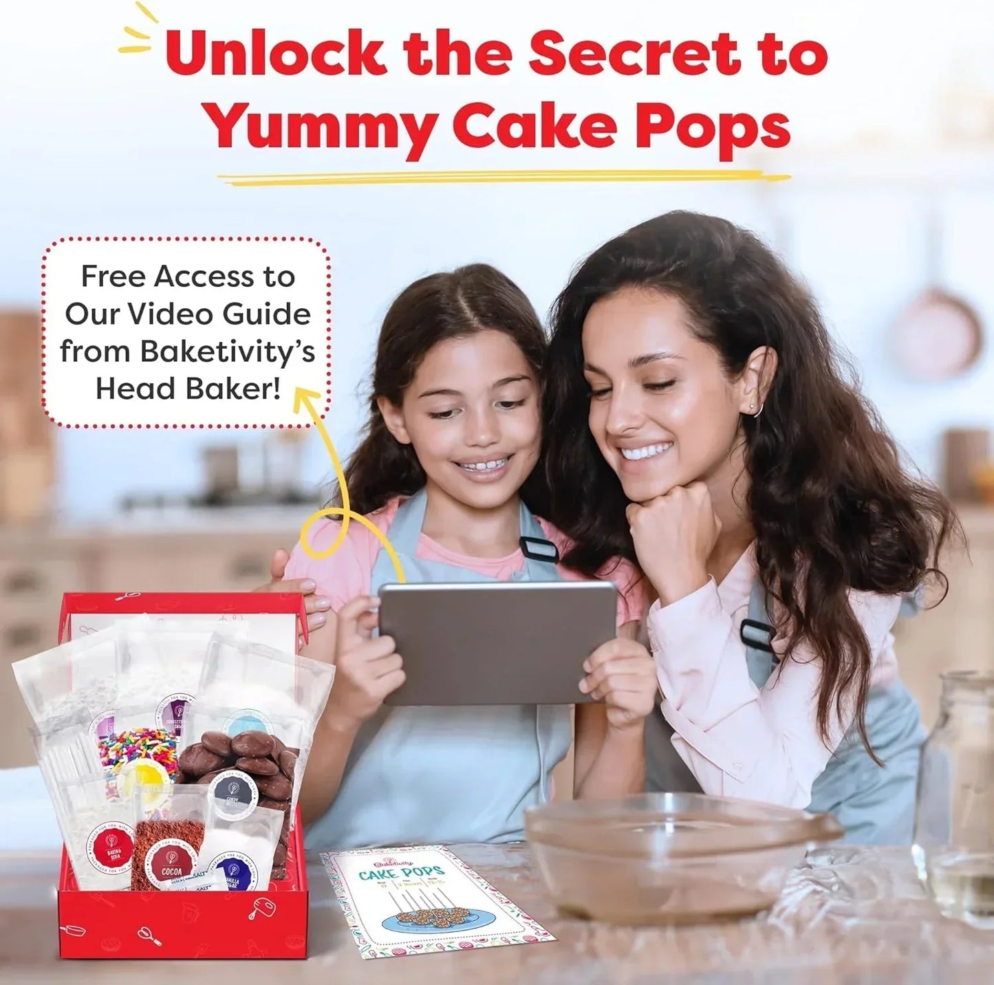 Mother and daughter baking cake pops with kit, watching video guide in kitchen
