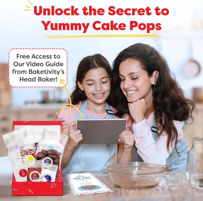 Mother and daughter baking cake pops with kit, watching video guide in kitchen