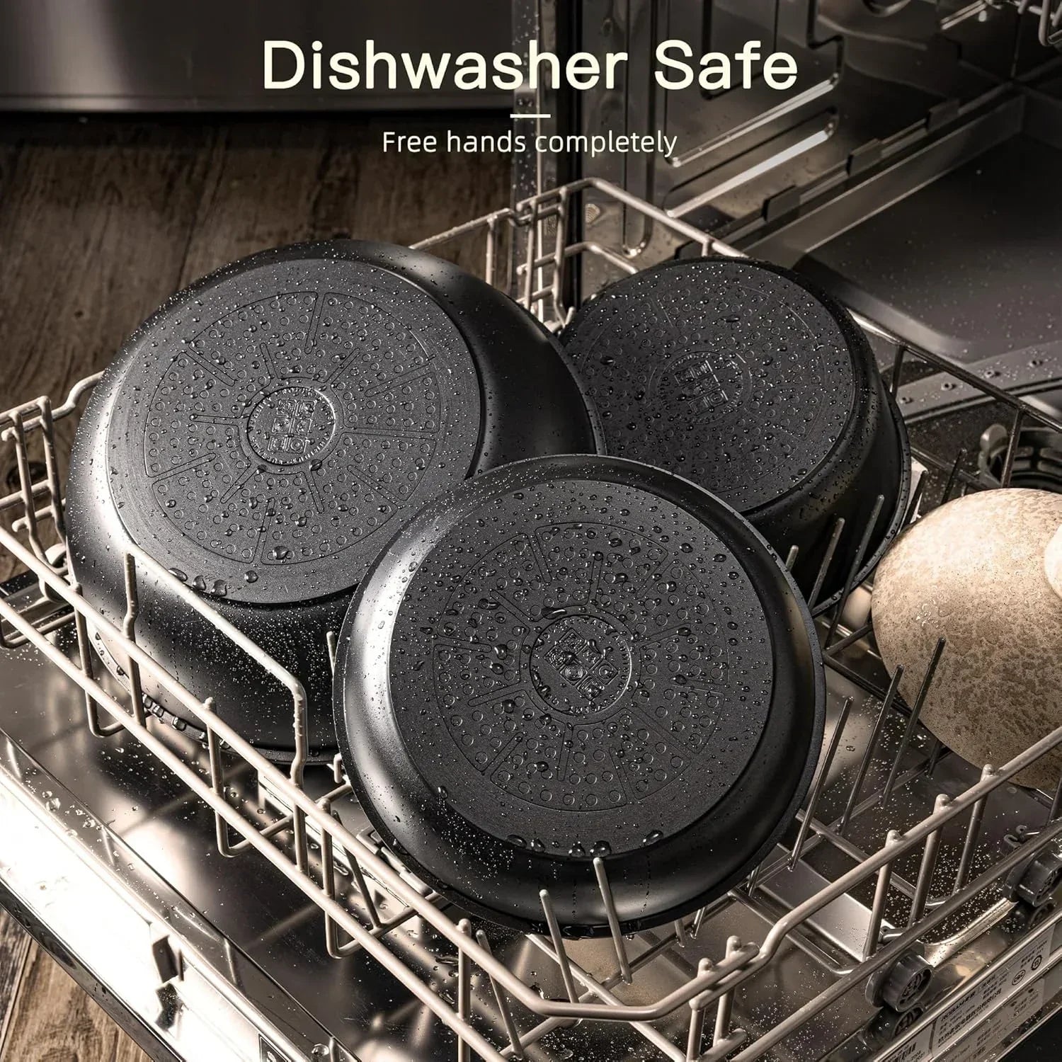 Nonstick cookware pans in dishwasher, showing water droplets, labeled dishwasher safe