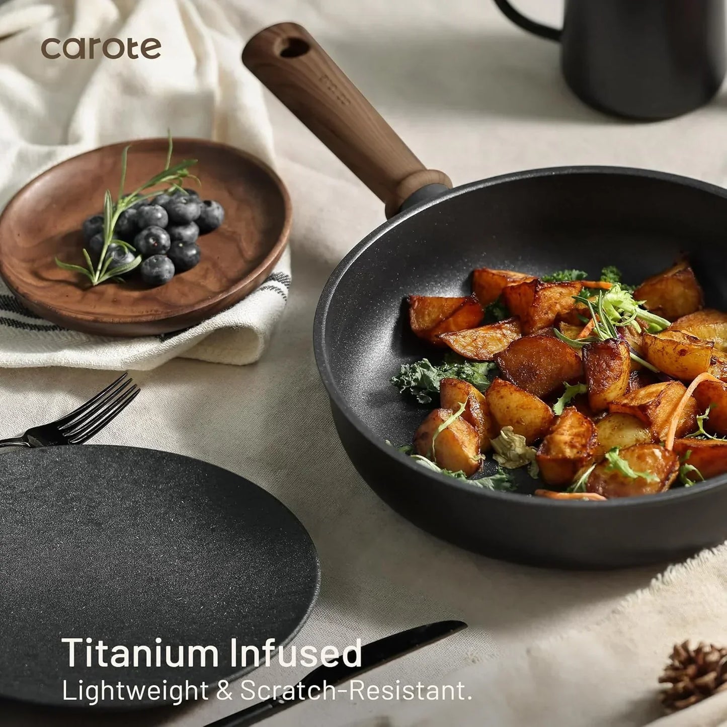 Titanium-infused nonstick frying pan with roasted potatoes, wooden handle, and kitchen table setting