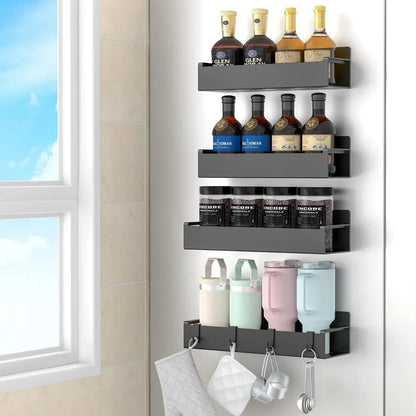 Wall-mounted black kitchen storage organizer holding bottles, jars, cups, and hanging utensils