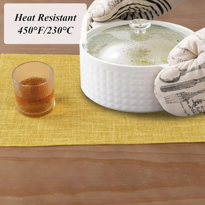 Heat-resistant yellow placemat under hot casserole dish, kitchen table setting with glass