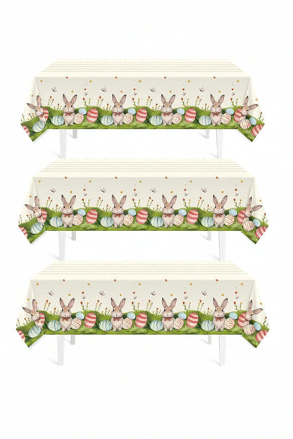 Easter tablecloth with bunnies and colorful eggs on green grass, perfect for spring gatherings and festive dining.