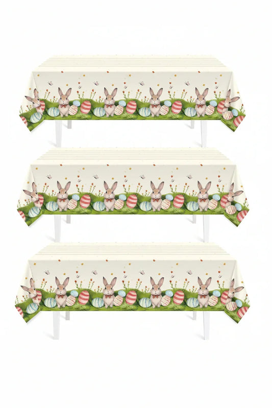 Easter tablecloth with bunnies and colorful eggs on green grass, perfect for spring gatherings and festive dining.