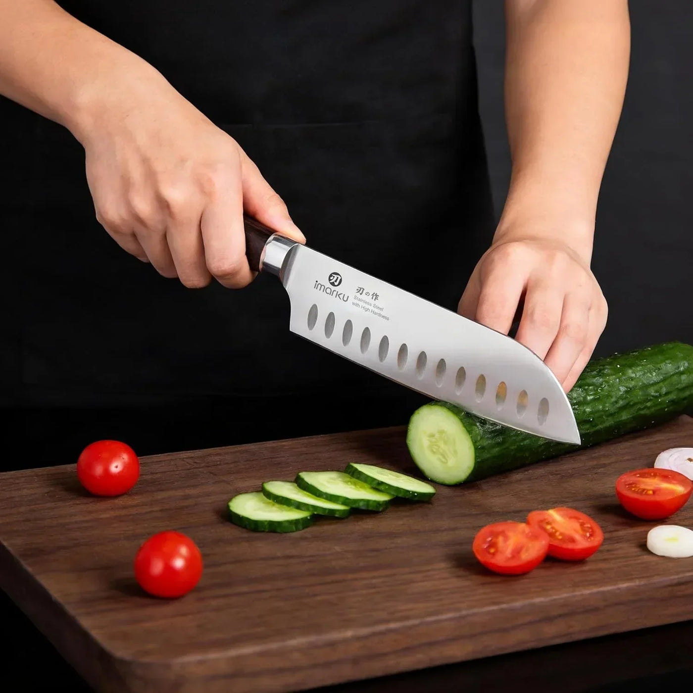Chef slicing cucumber with a stainless steel kitchen knife on a wooden cutting board