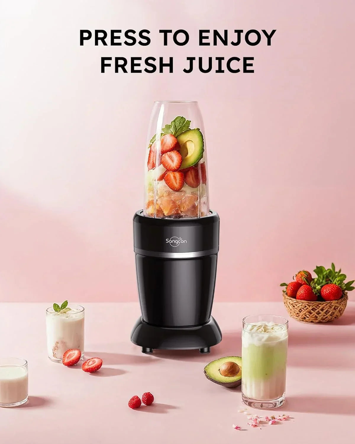 Black blender with strawberries and avocado, fresh juice setup on pink background